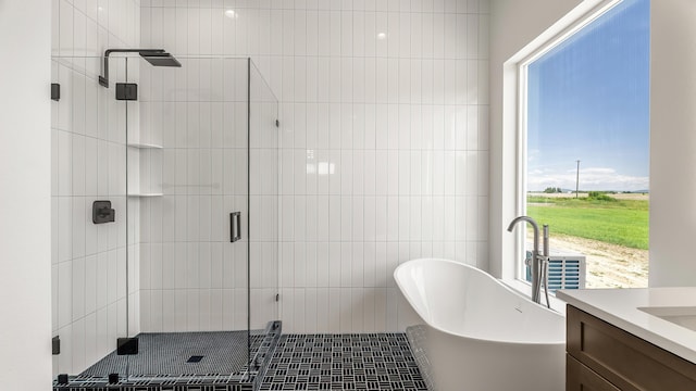 8521 W Dahl Rd, Deer Park, WA 99006 - full bathroom with a freestanding tub, vanity, and a stall shower