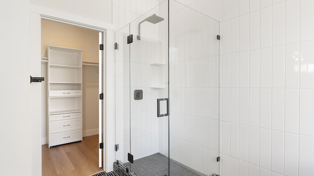 8521 W Dahl Rd, Deer Park, WA 99006 - full bathroom featuring a stall shower, wood finished floors, and a walk in closet
