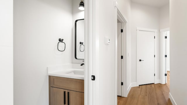 8521 W Dahl Rd, Deer Park, WA 99006 - bathroom featuring vanity, wood finished floors, and baseboards