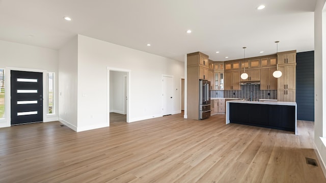 8521 W Dahl Rd, Deer Park, WA 99006 - kitchen with high quality fridge, light countertops, open floor plan, decorative backsplash, and recessed lighting