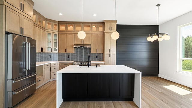8521 W Dahl Rd, Deer Park, WA 99006 - kitchen featuring high end refrigerator, a sink, light countertops, baseboards, and decorative backsplash