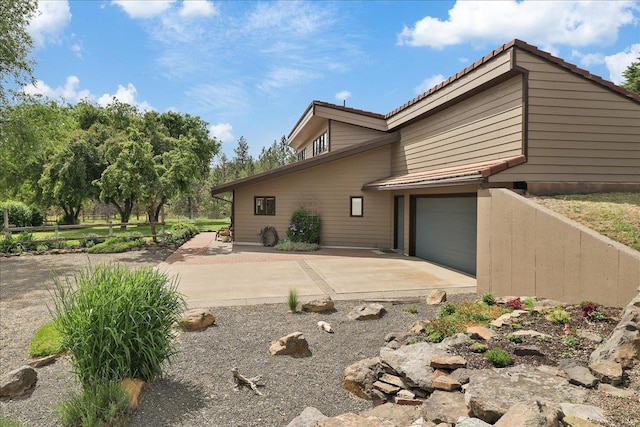 21123 S Cheney Spangle Rd, Cheney, WA 99004 - view of property exterior featuring a tiled roof and concrete driveway