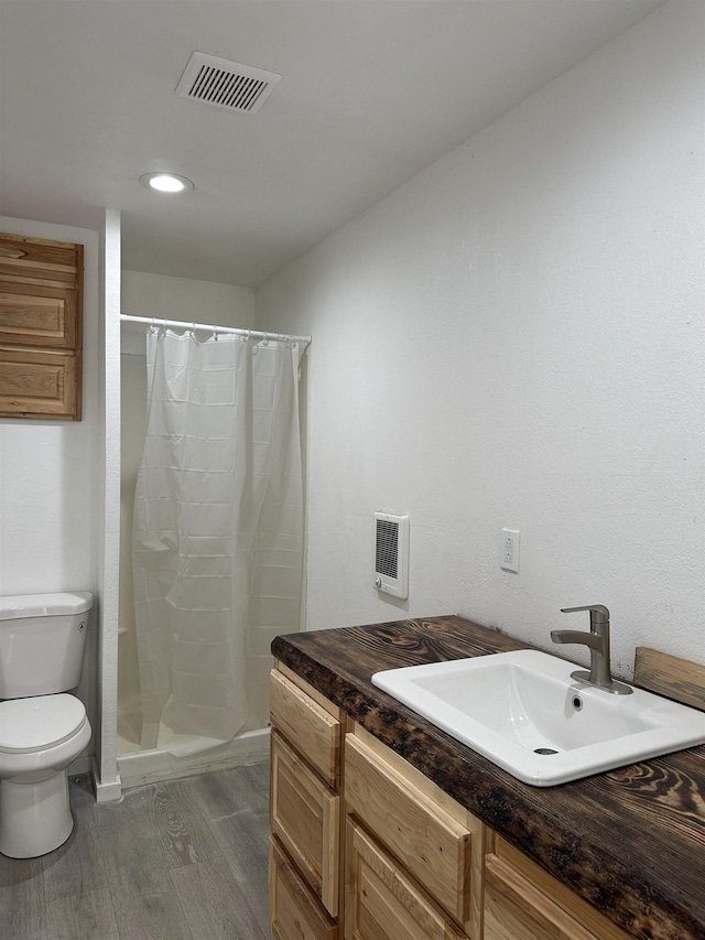 30710 N Newport Hwy, Chattaroy, WA 99003 - full bath featuring toilet, wood finished floors, vanity, curtained shower, and baseboards