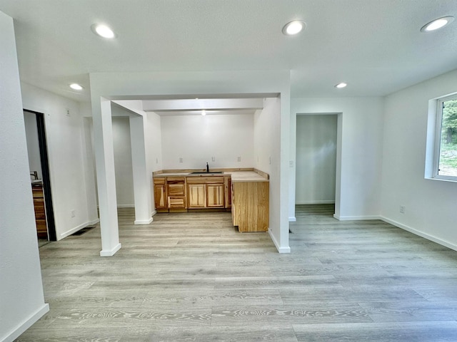 30710 N Newport Hwy, Chattaroy, WA 99003 - kitchen featuring a sink, light countertops, light wood-style floors, recessed lighting, and baseboards