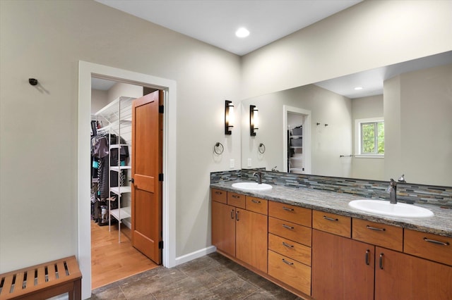 15415 E Timbercrest Ln, Mead, WA 99021 - bathroom featuring double vanity, a spacious closet, backsplash, and recessed lighting