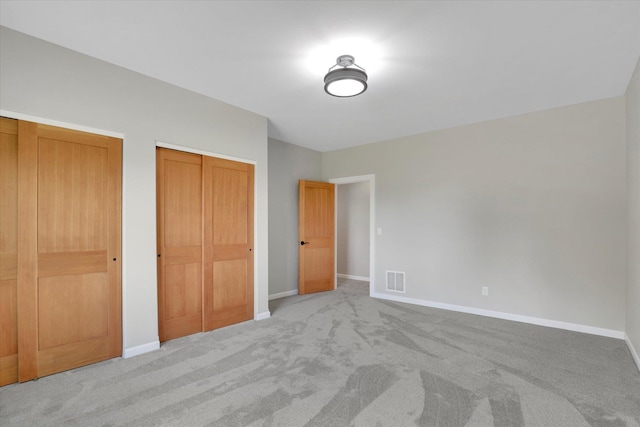 15415 E Timbercrest Ln, Mead, WA 99021 - unfurnished bedroom featuring carpet flooring, baseboards, and multiple closets