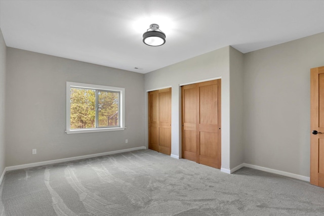 15415 E Timbercrest Ln, Mead, WA 99021 - unfurnished bedroom featuring multiple closets, carpet floors, and baseboards