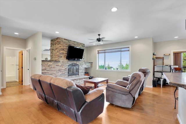 15415 E Timbercrest Ln, Mead, WA 99021 - living area with light wood finished floors, ceiling fan, baseboards, recessed lighting, and a wood stove