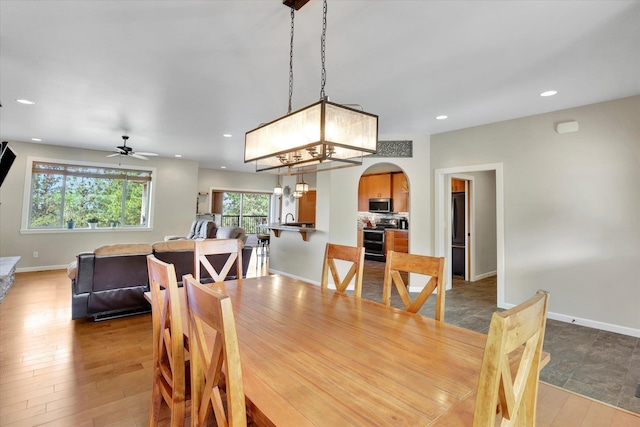 15415 E Timbercrest Ln, Mead, WA 99021 - dining room featuring arched walkways, a ceiling fan, baseboards, recessed lighting, and light wood-type flooring
