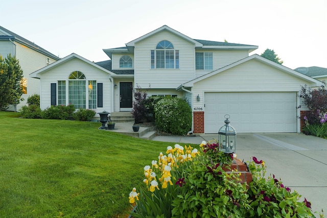 6706 S Moran View St, Spokane, WA 99224 - split level home with a front lawn, a garage, concrete driveway, brick siding, and roof with shingles