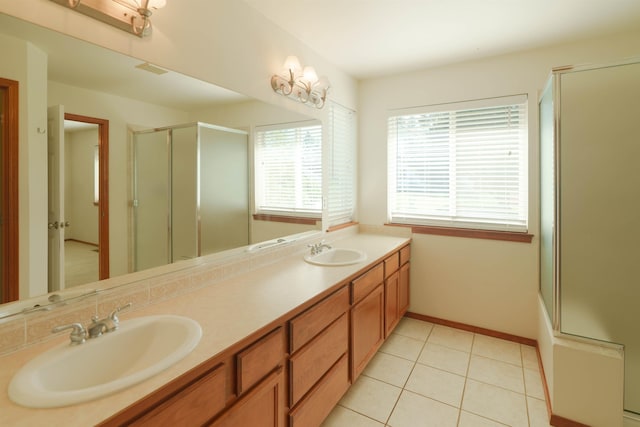 6706 S Moran View St, Spokane, WA 99224 - bathroom featuring an enclosed shower, double vanity, tile patterned floors, and baseboards