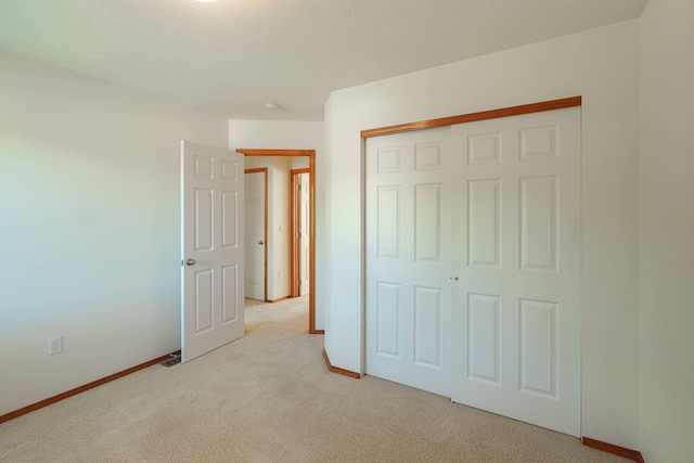 6706 S Moran View St, Spokane, WA 99224 - unfurnished bedroom featuring light carpet, baseboards, and a closet