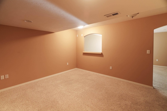 6706 S Moran View St, Spokane, WA 99224 - unfurnished room with carpet flooring, baseboards, and arched walkways