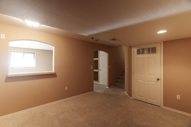 6706 S Moran View St, Spokane, WA 99224 - carpeted empty room with arched walkways, stairs, a textured ceiling, recessed lighting, and baseboards