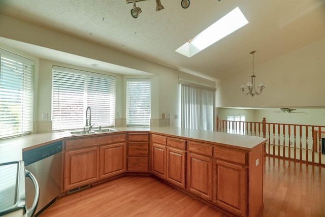 6706 S Moran View St, Spokane, WA 99224 - kitchen with a sink, dishwasher, light wood-type flooring, a skylight, and light countertops