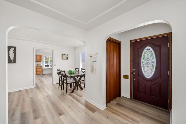 2603 E Wellesley Ave, Spokane, WA 99217 - foyer with arched walkways, light wood-type flooring, and baseboards
