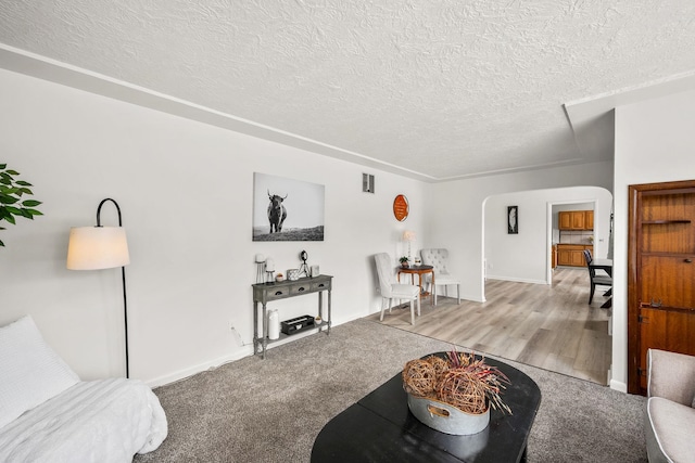 2603 E Wellesley Ave, Spokane, WA 99217 - living room with a textured ceiling, arched walkways, and baseboards