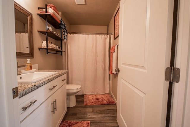 3414 N Lee St, Spokane, WA 99207 - bathroom featuring wood finished floors, vanity, toilet, and a shower with shower curtain