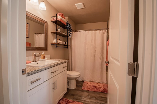 3414 N Lee St, Spokane, WA 99207 - bathroom with vanity, toilet, wood finished floors, and curtained shower