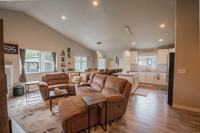 3414 N Lee St, Spokane, WA 99207 - living room featuring lofted ceiling, plenty of natural light, wood finished floors, recessed lighting, and baseboards