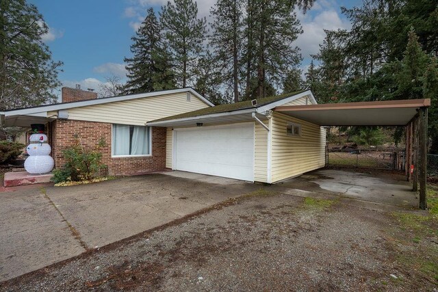 13524 E Nora Avenue 1609 & 1619N Mamer Rd, Spokane Valley, WA 99216 - view of front of house featuring a chimney, brick siding, a garage, and driveway