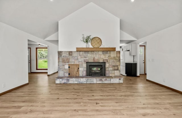 12411 E Gibbs Rd, Mica, WA 99023 - unfurnished living room with light wood finished floors, baseboards, and high vaulted ceiling