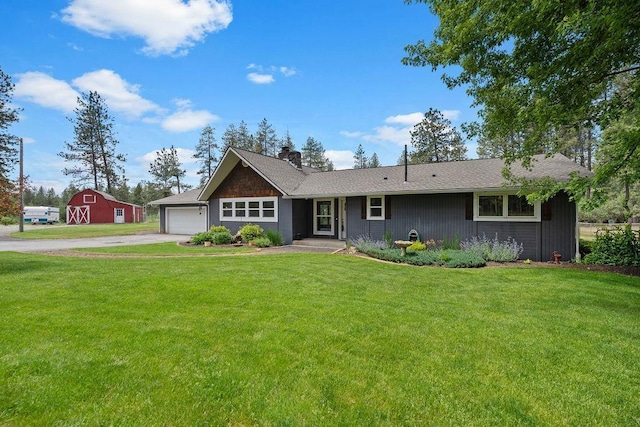 12411 E Gibbs Rd, Mica, WA 99023 - ranch-style house with a front yard, asphalt driveway, a chimney, and a garage