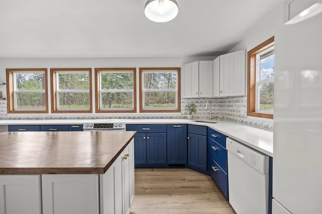 12411 E Gibbs Rd, Mica, WA 99023 - kitchen with white appliances, blue cabinetry, butcher block counters, a sink, and white cabinetry