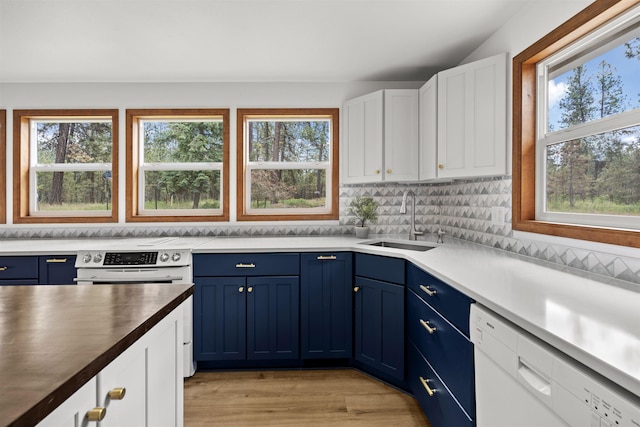 12411 E Gibbs Rd, Mica, WA 99023 - kitchen featuring blue cabinets, a sink, plenty of natural light, and white cabinets