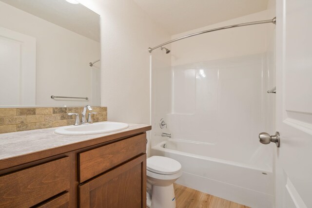 10214 W January Ct, Cheney, WA 99004 - full bathroom featuring vanity, toilet, shower / bath combination, decorative backsplash, and wood finished floors