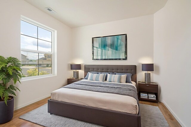 10214 W January Ct, Cheney, WA 99004 - bedroom with multiple windows, wood finished floors, and baseboards