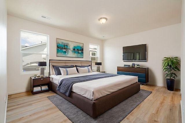 10214 W January Ct, Cheney, WA 99004 - bedroom with light wood-style flooring, multiple windows, and baseboards