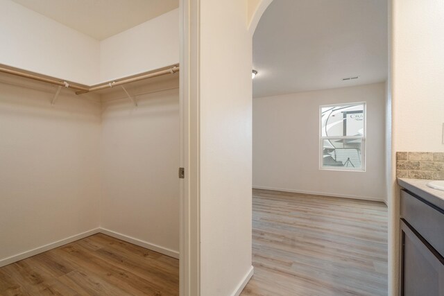 10214 W January Ct, Cheney, WA 99004 - spacious closet featuring light wood-style flooring and arched walkways