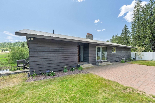 252 Davaz-Carlton Rd, Newport, WA 99156 - rear view of house with a chimney and a patio area