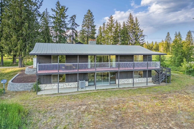 252 Davaz-Carlton Rd, Newport, WA 99156 - rear view of house featuring a patio, a chimney, central air condition unit, and stone siding