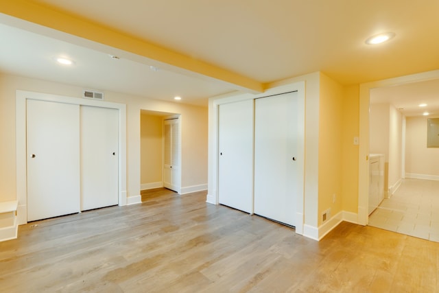 523 S Hatch St, Spokane, WA 99202 - unfurnished bedroom featuring two closets, recessed lighting, light wood-style flooring, washer / dryer, and baseboards