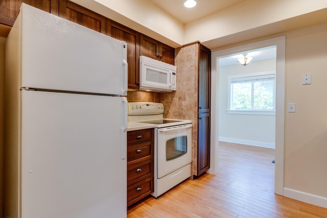 523 S Hatch St, Spokane, WA 99202 - kitchen with white appliances, baseboards, light wood finished floors, light countertops, and tasteful backsplash