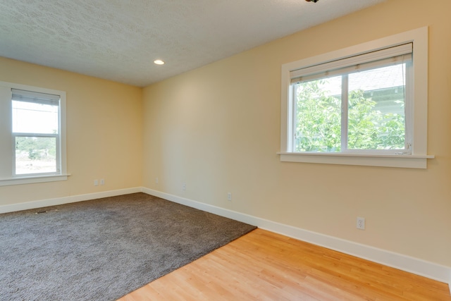523 S Hatch St, Spokane, WA 99202 - unfurnished room with baseboards, wood finished floors, a textured ceiling, and recessed lighting
