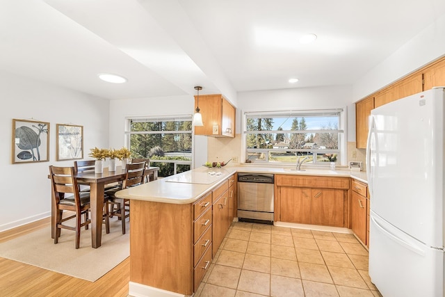 3342 W Riverview Dr, Spokane, WA 99205 - kitchen featuring freestanding refrigerator, stainless steel dishwasher, a peninsula, light countertops, and recessed lighting