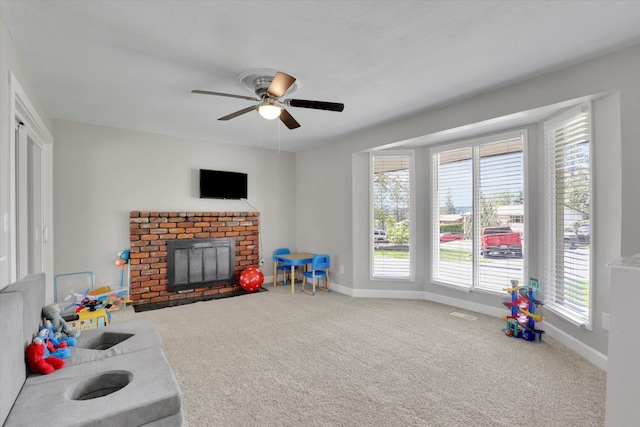 8428 N Susan Ct, Spokane, WA 99208 - carpeted living area with a brick fireplace, ceiling fan, and baseboards