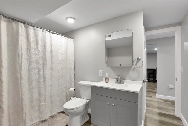 8428 N Susan Ct, Spokane, WA 99208 - full bath with wood finished floors, vanity, toilet, baseboards, and a shower with shower curtain