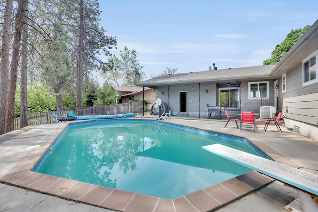 8428 N Susan Ct, Spokane, WA 99208 - view of pool with a patio area, a fenced backyard, a diving board, and central air condition unit