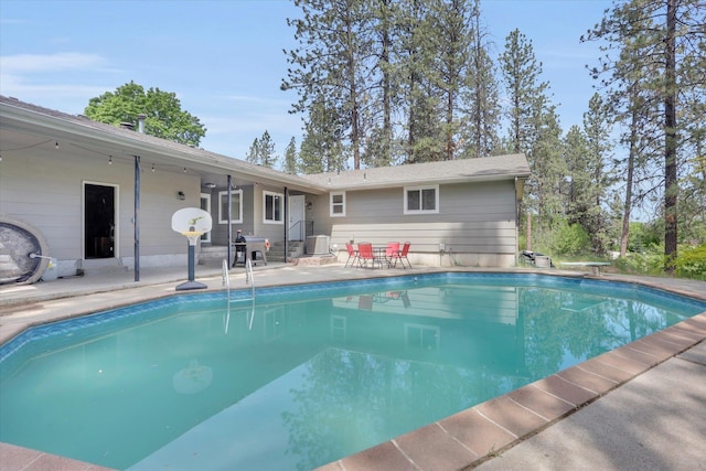 8428 N Susan Ct, Spokane, WA 99208 - outdoor pool with a patio, a diving board, and central AC