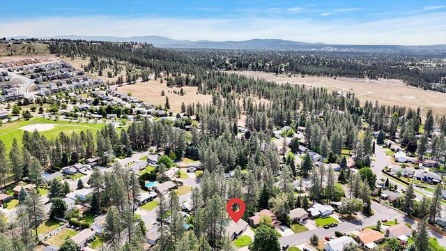 8428 N Susan Ct, Spokane, WA 99208 - view of property location with a mountain backdrop, a forest, and nearby suburban area