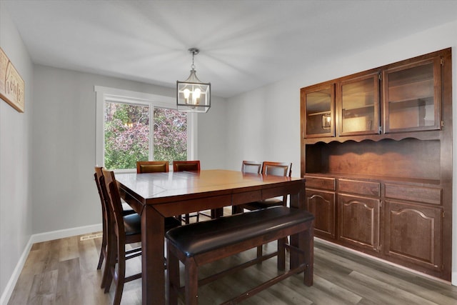 8428 N Susan Ct, Spokane, WA 99208 - dining room with light wood-style floors, a chandelier, and baseboards
