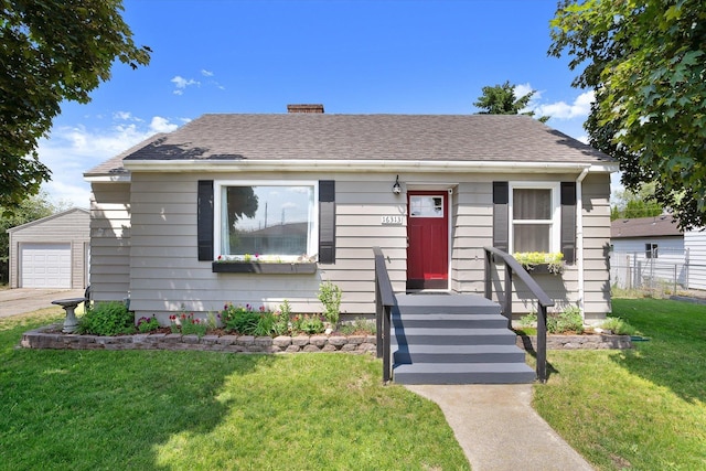 16313 E Riverside Ave, Veradale, WA 99037 - bungalow-style home featuring a chimney, an outbuilding, roof with shingles, and a detached garage