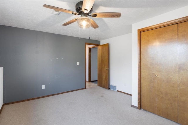 6106 W Kittitas Ct, Spokane, WA 99208 - unfurnished bedroom with a closet, carpet, baseboards, ceiling fan, and a textured ceiling