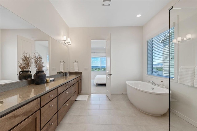 4756 W Lex Ave, Spokane, WA 99208 - bathroom featuring double vanity, a freestanding tub, baseboards, and ensuite bathroom