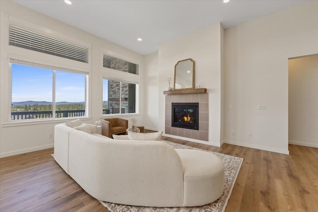 4756 W Lex Ave, Spokane, WA 99208 - living room featuring a tile fireplace, baseboards, wood finished floors, a mountain view, and recessed lighting
