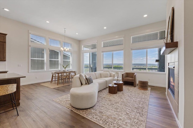 4756 W Lex Ave, Spokane, WA 99208 - living area featuring wood finished floors, baseboards, a glass covered fireplace, recessed lighting, and a chandelier